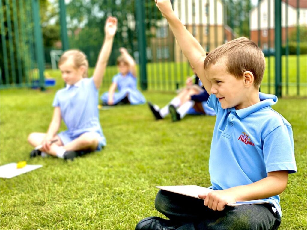 pupils answering question outside