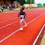 pupil taking part in race on track